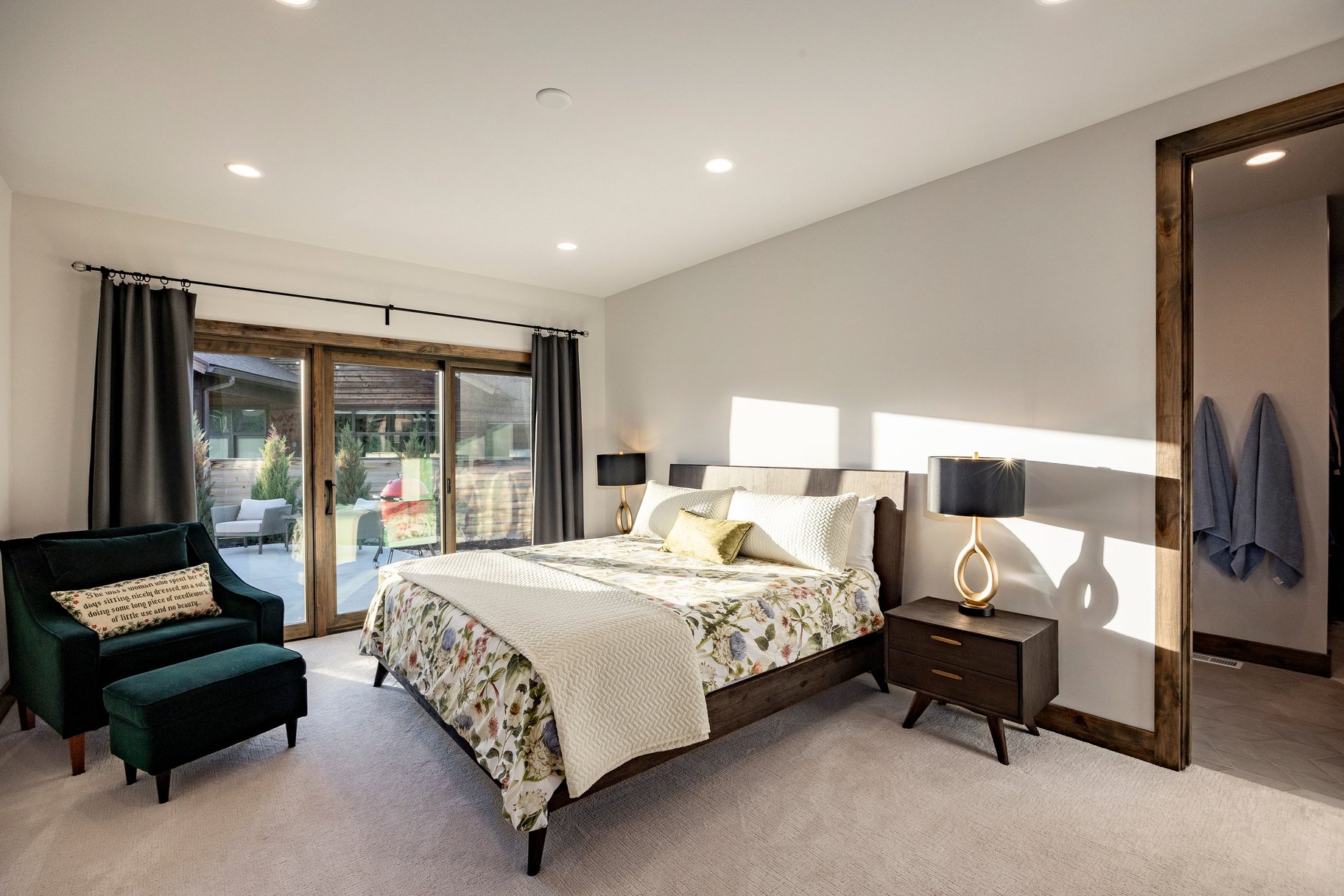 Recessed lighting illuminates this room, featuring light-toned carpeting and neutral wall paint