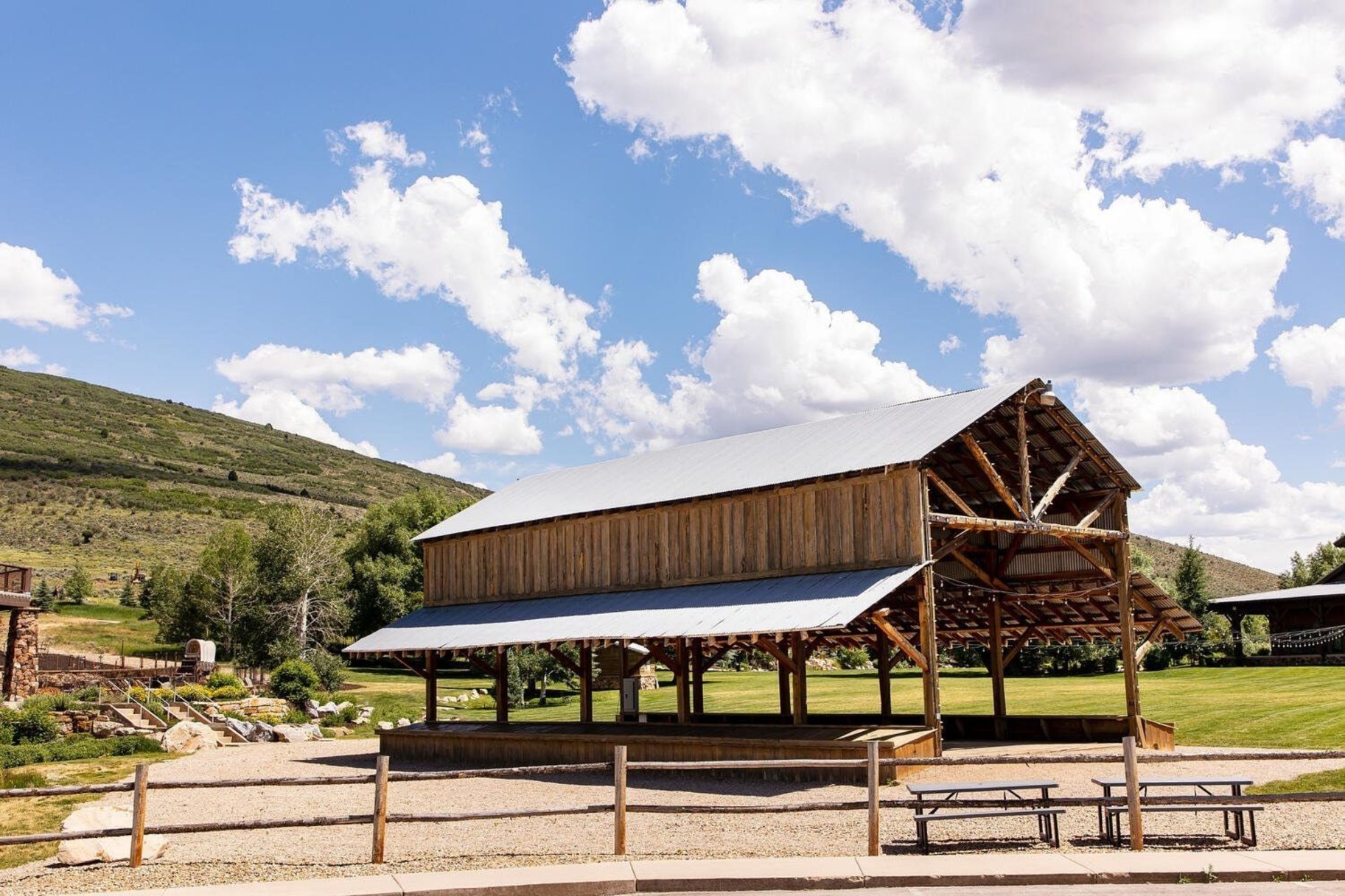 Spacious open-air pavilion featuring exposed timber framing and a metal roof