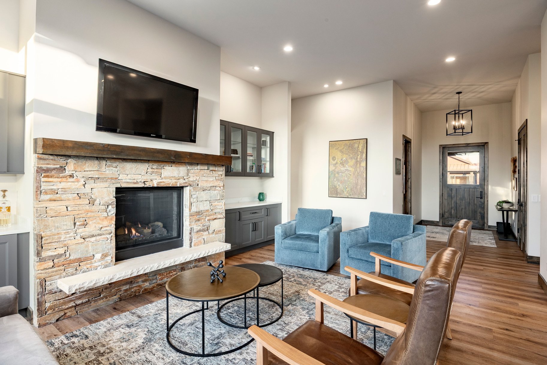 Stone-clad fireplace with a wood mantel and hearth