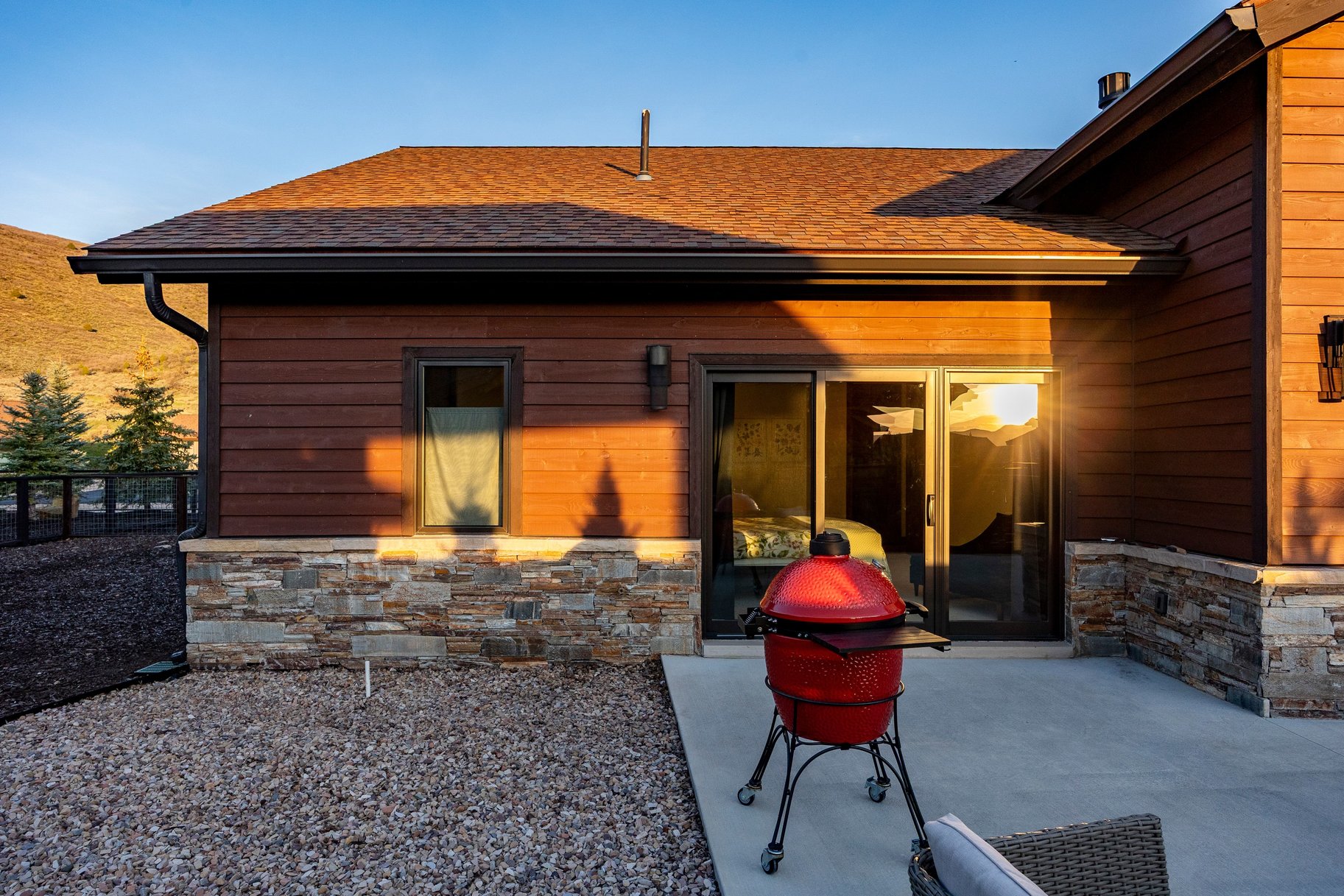 Exterior showcasing wood-finish siding over a stone veneer foundation