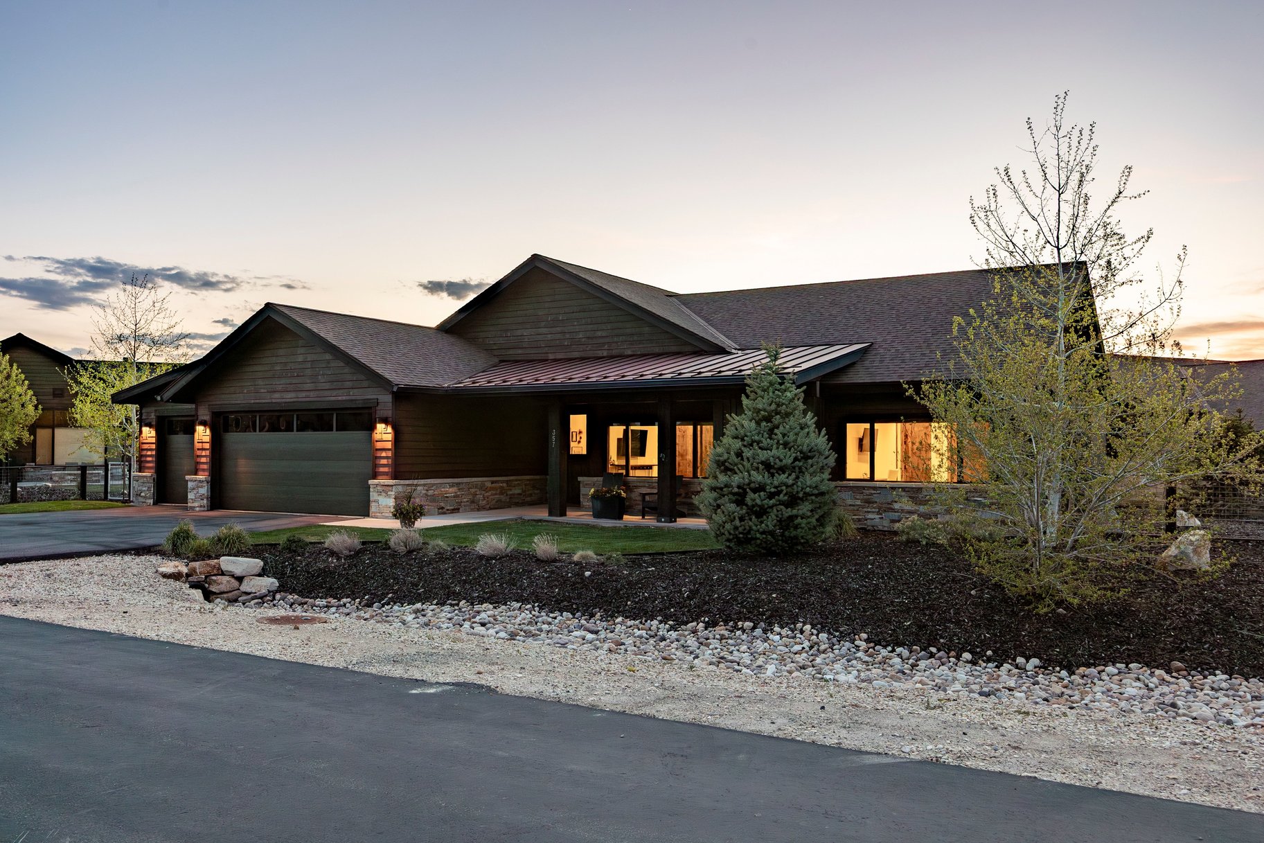 Craftsman-style home featuring a stone and wood-look exterior