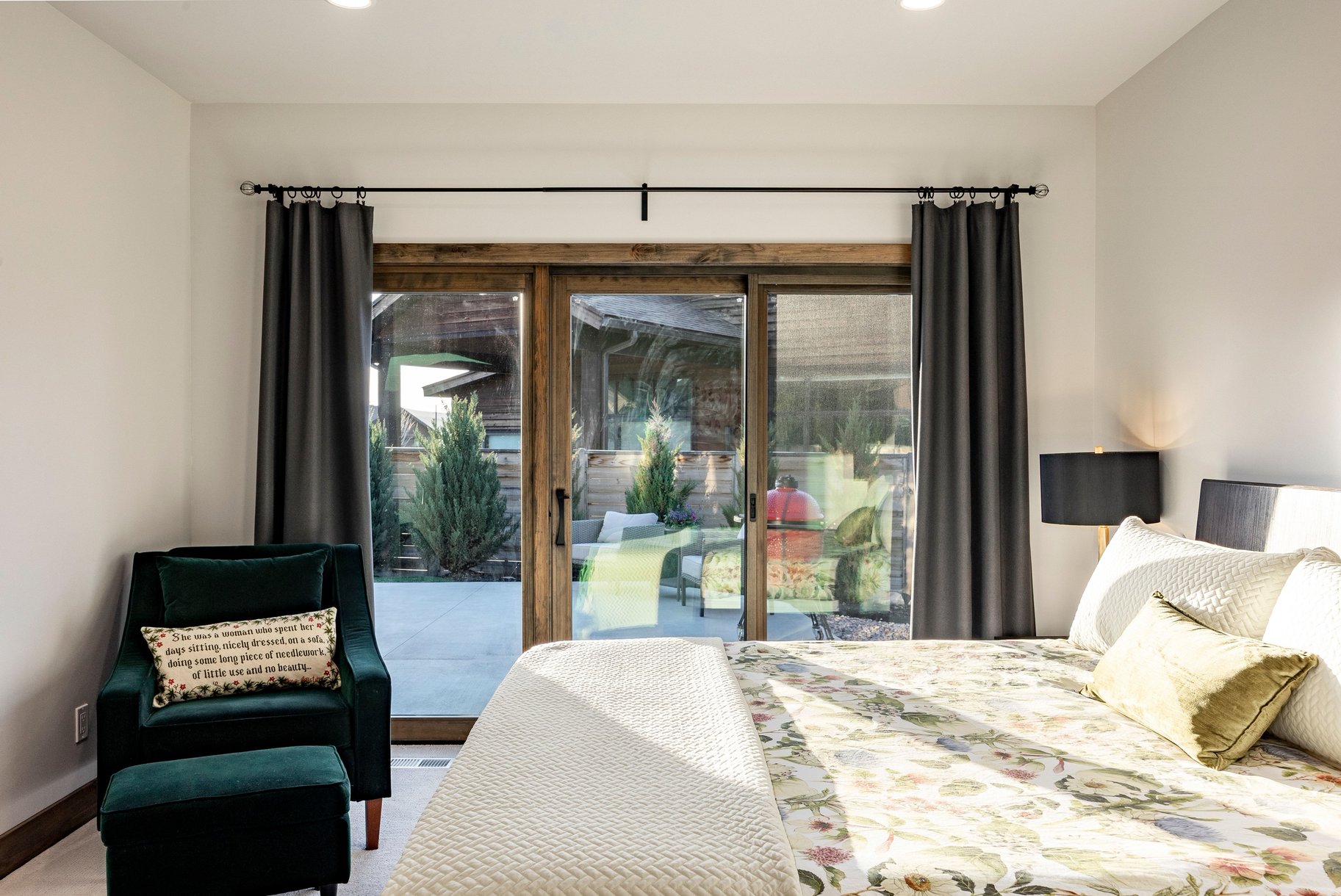Sliding glass doors with wood-finish frames open to an outdoor patio area