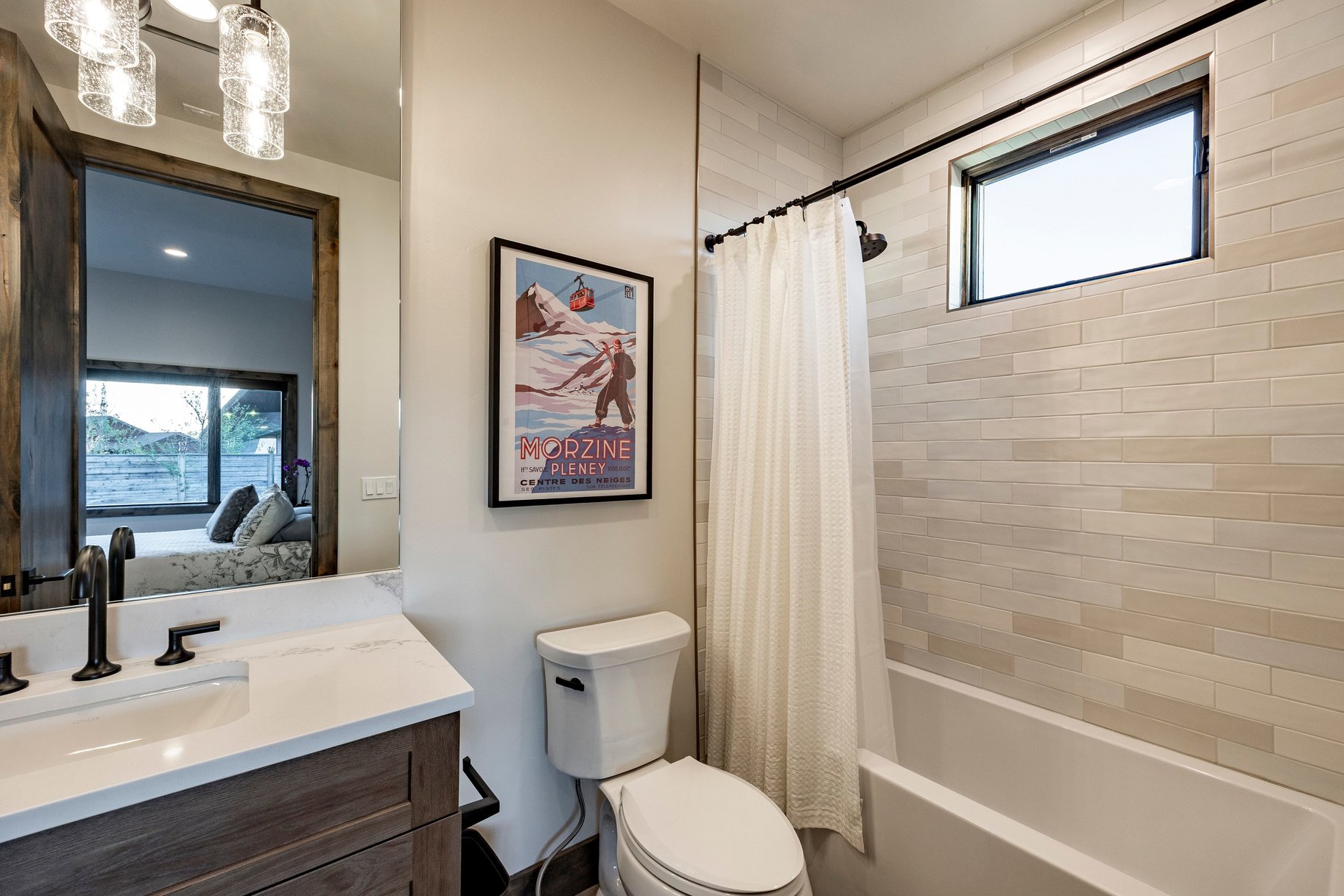 Bathroom featuring a wood-finish vanity with a white countertop and rectangular sink