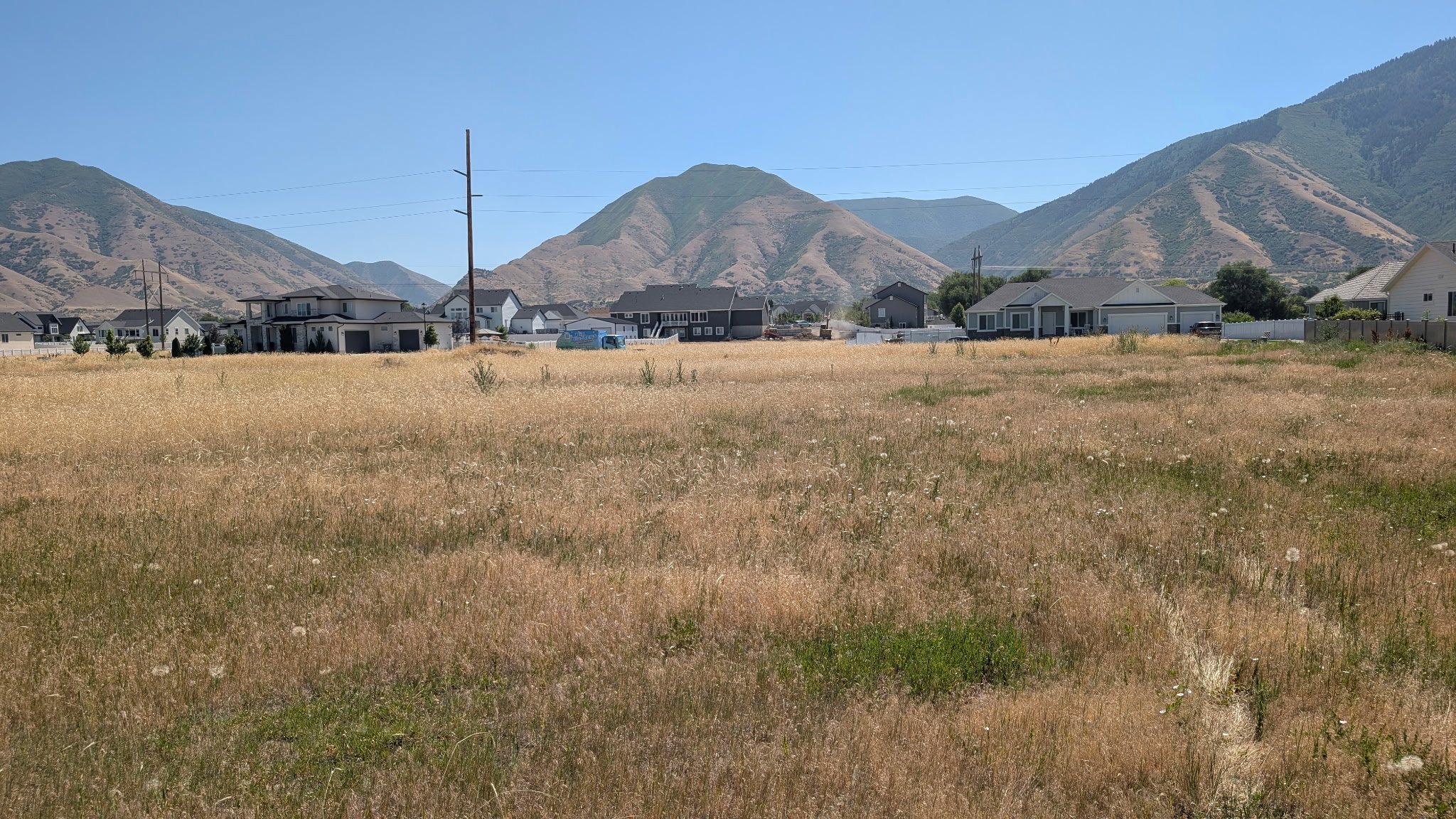 Expansive undeveloped parcel featuring natural vegetation and surrounding mountain scenery