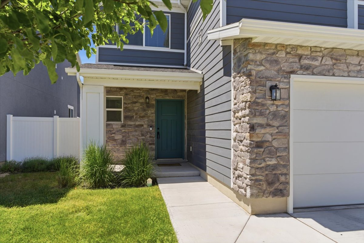Contemporary exterior featuring gray horizontal siding and a stone facade