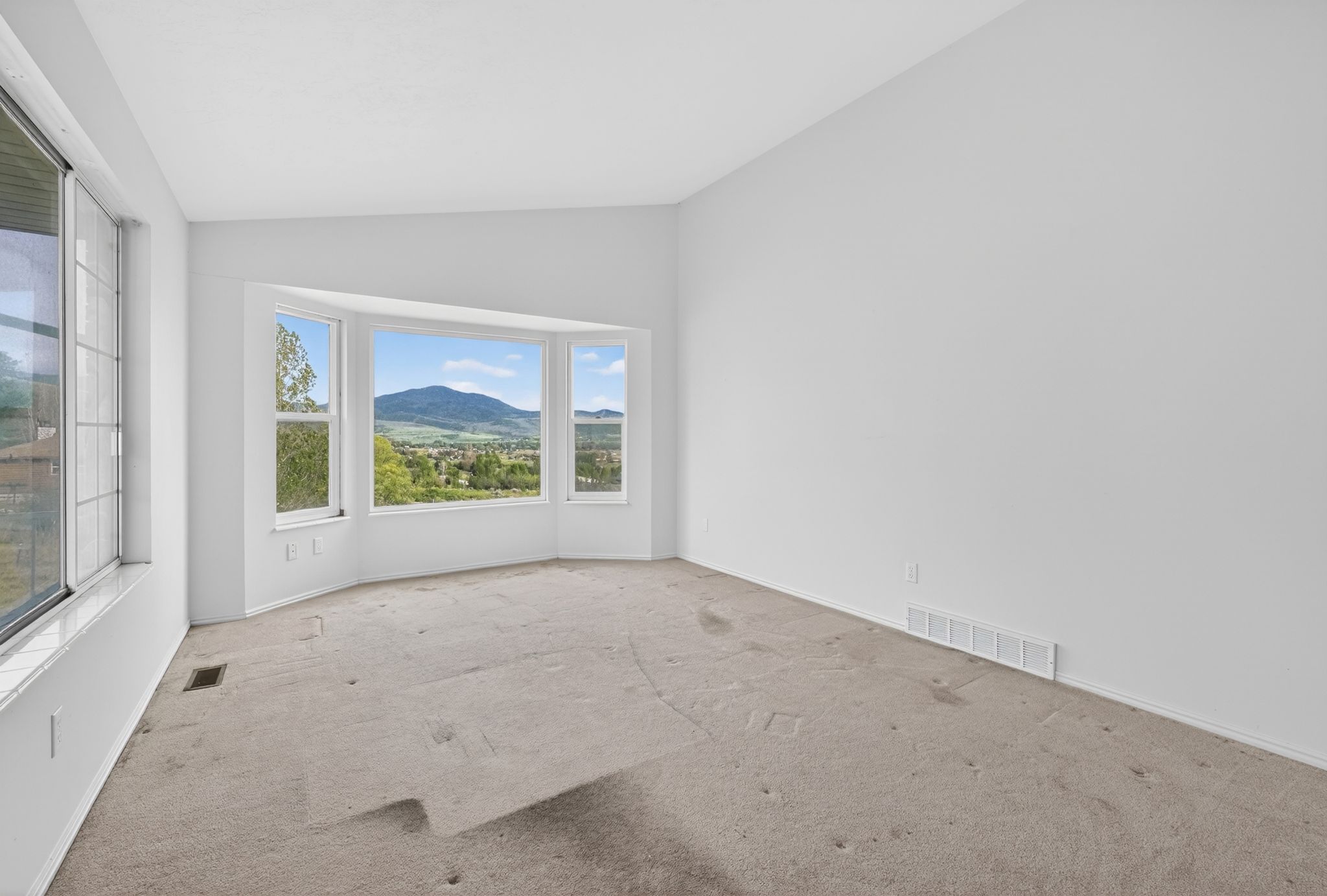 Expansive bay window framing distant mountains and surrounding landscape