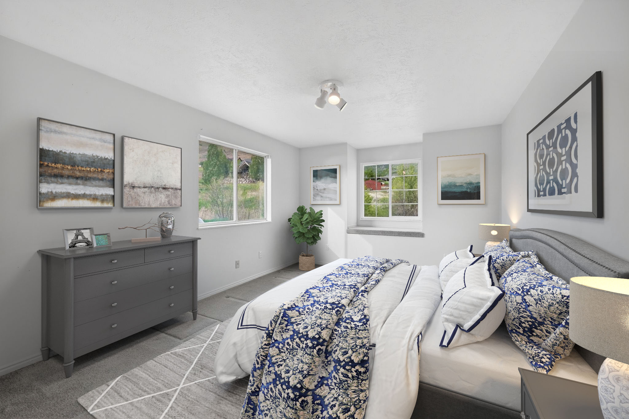 Bedroom featuring multiple windows, light-colored walls, and a track lighting fixture