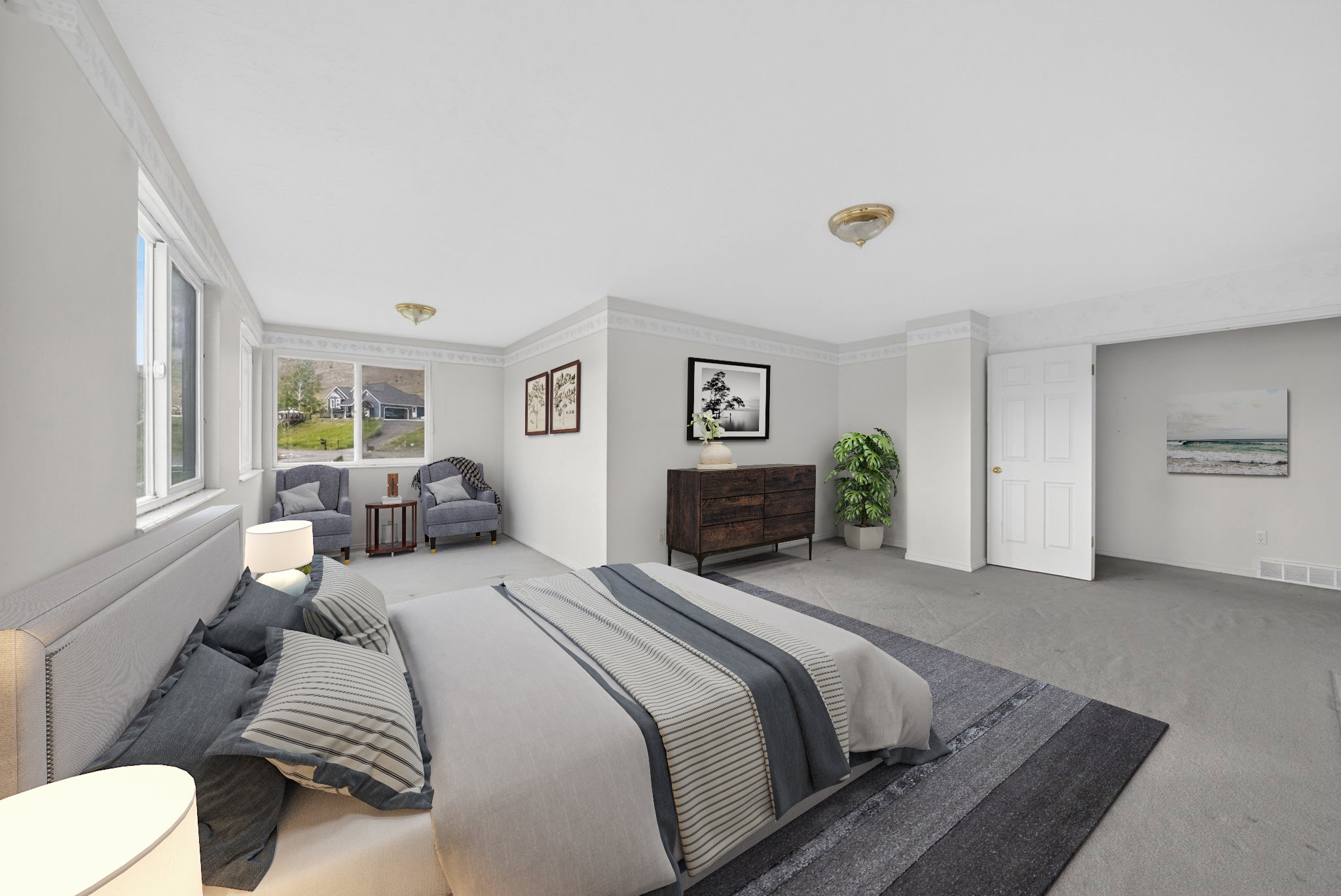 Spacious room featuring light gray walls, white trim, and a wall of windows offering natural light