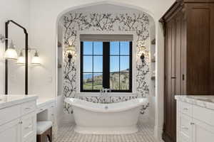 Freestanding soaking tub set against a black-framed window with a scenic backdrop, flanked by decorative wallpaper