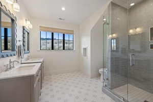 Dual vanity featuring scalloped mirrors and polished chrome fixtures