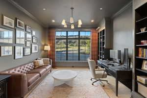 Expansive window with black grid panes, integrated built-in shelving, wood-finish flooring, recessed lighting, and crown molding