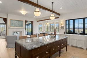 Central kitchen island featuring a substantial stone countertop
