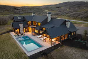 Contemporary dark-clad residence featuring a multi-level design and a dark shingle roof