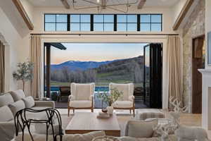 Expansive living area with high ceilings and wood-finish flooring