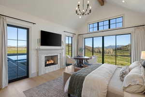 Vaulted ceiling with exposed wood beam and chandelier