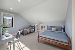 Carpeted room with sloped ceilings and light blue walls