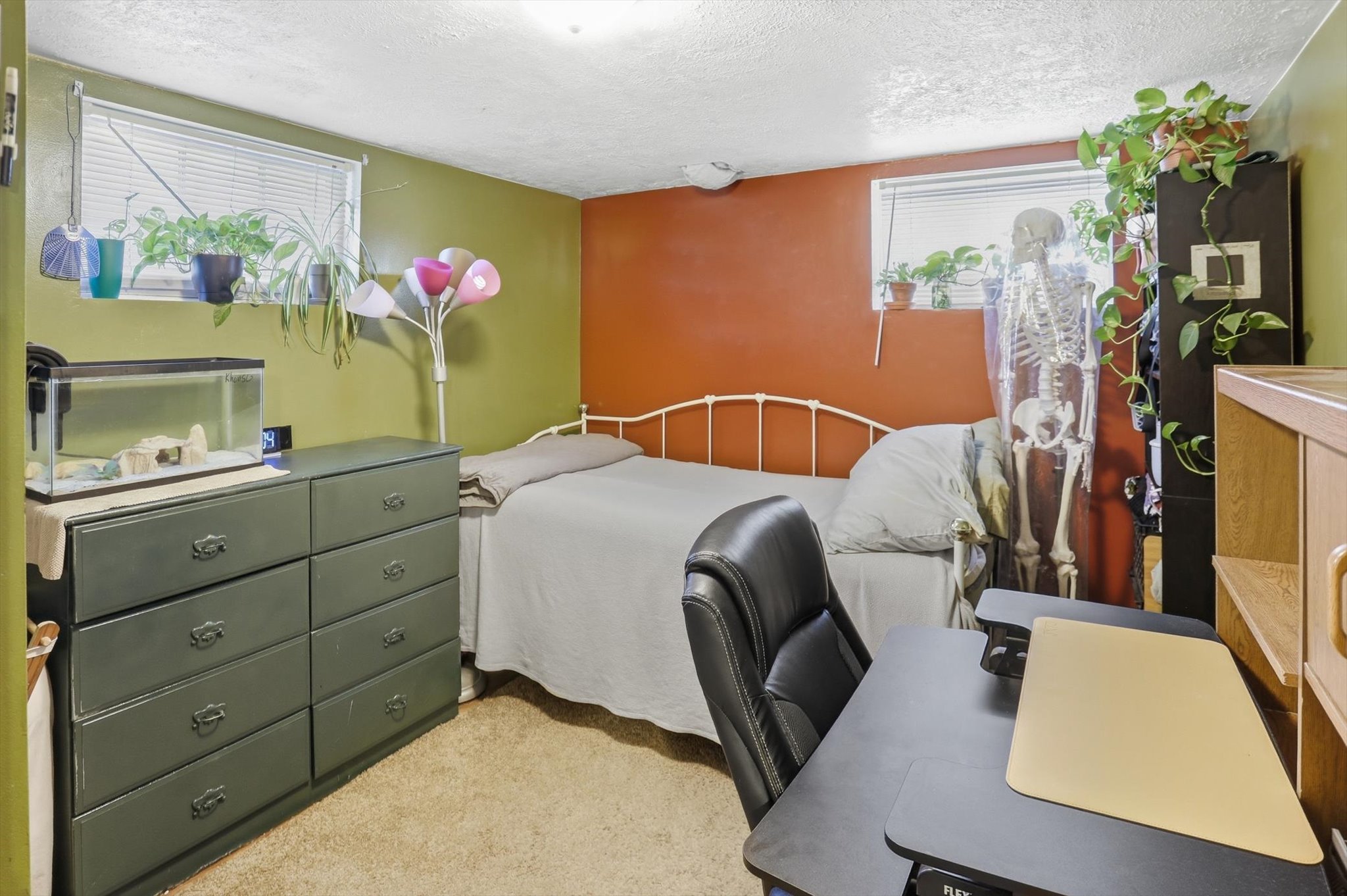 Carpeted room featuring a window with blinds, painted walls, and a recessed ceiling light