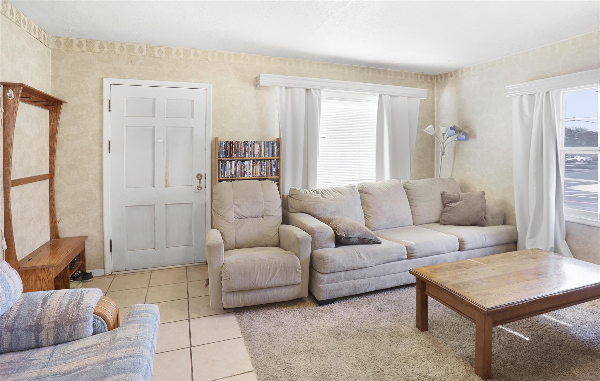 Living area with neutral-toned wall finish and white trim