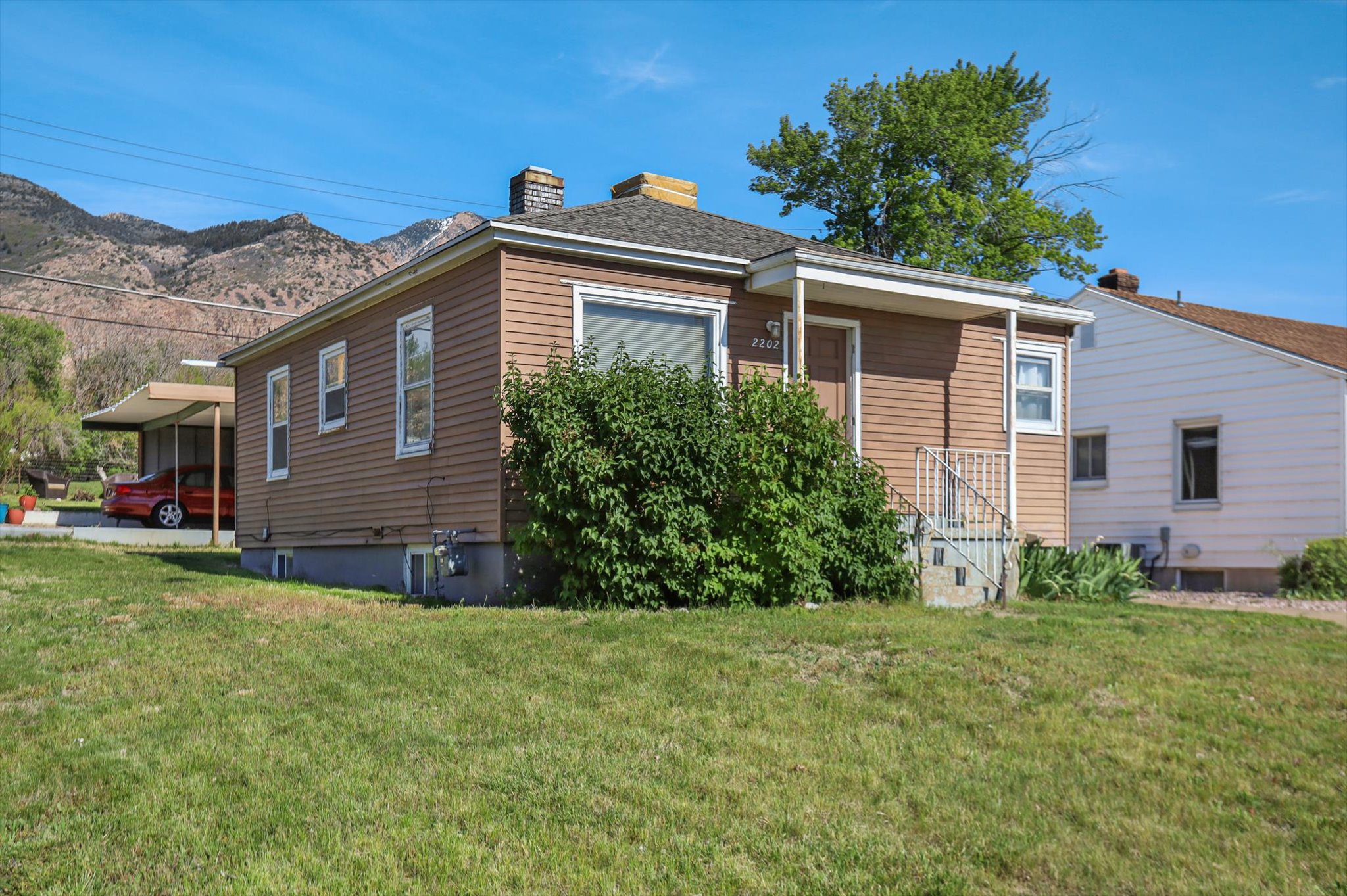 Single-story residential structure with horizontal siding and a covered front entry