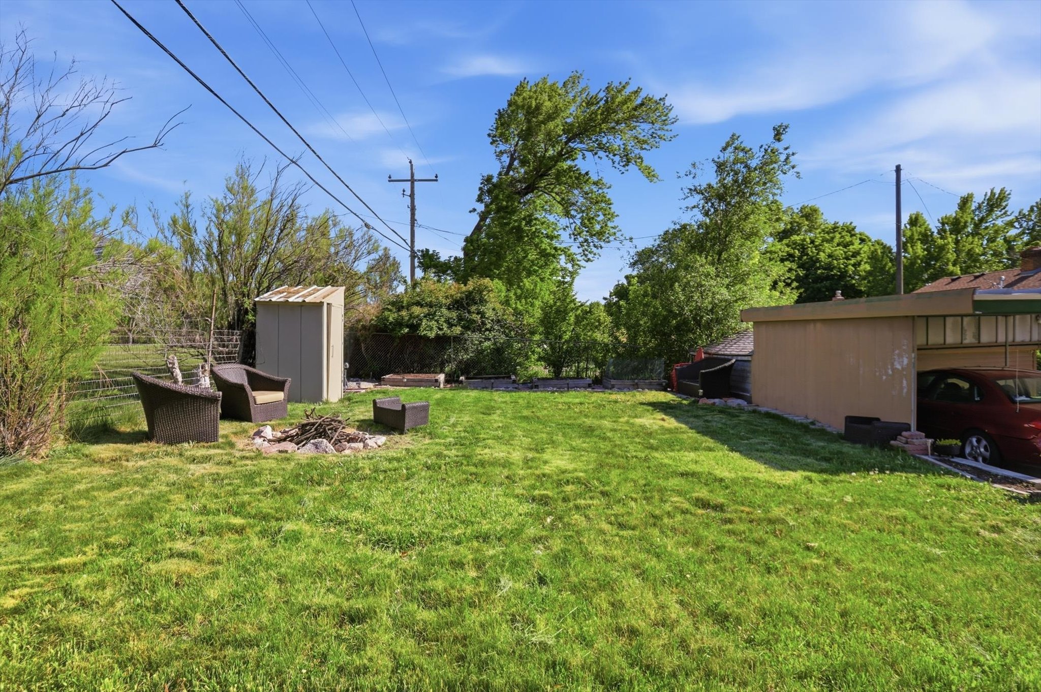 Expansive lawn area with a fire pit feature