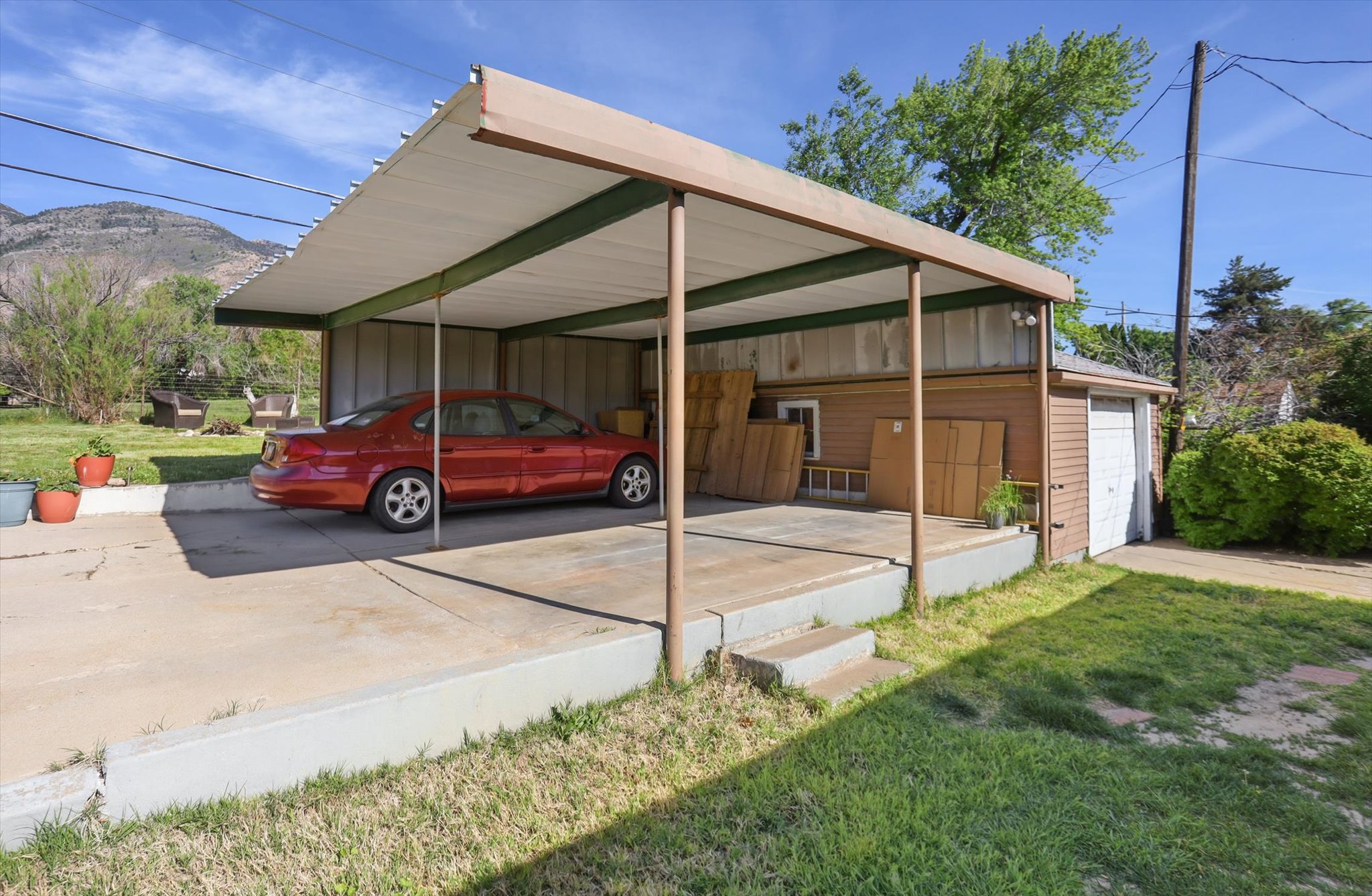Carport structure with a flat roof and metal supports