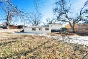 Expansive lawn area with a white exterior structure featuring multiple windows