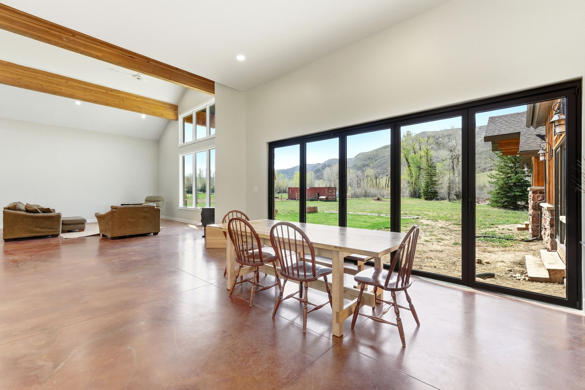 Expansive interior with polished concrete flooring and exposed wood beams