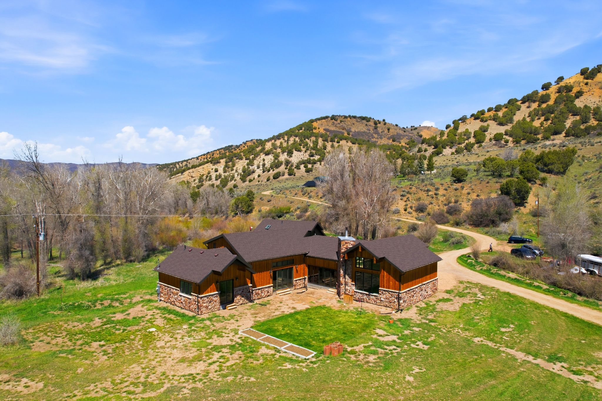 Ranch-style residence featuring brown siding and a stone-clad base