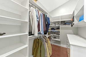 Custom closet system featuring white shelving and hanging rods