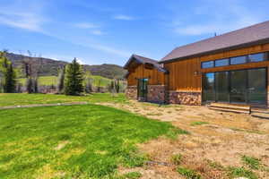 Exterior facade featuring natural wood siding and stone accents