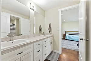 Dual vanity with white cabinetry, light-toned countertop, and undermount sinks