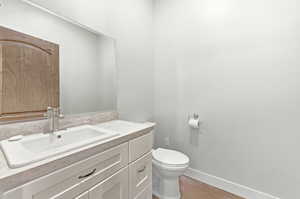 Modern bathroom vanity featuring white shaker-style cabinetry, an integrated white sink, and a brushed nickel faucet