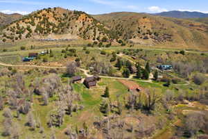 Expansive rural property featuring multiple residences, mature trees, and natural waterways