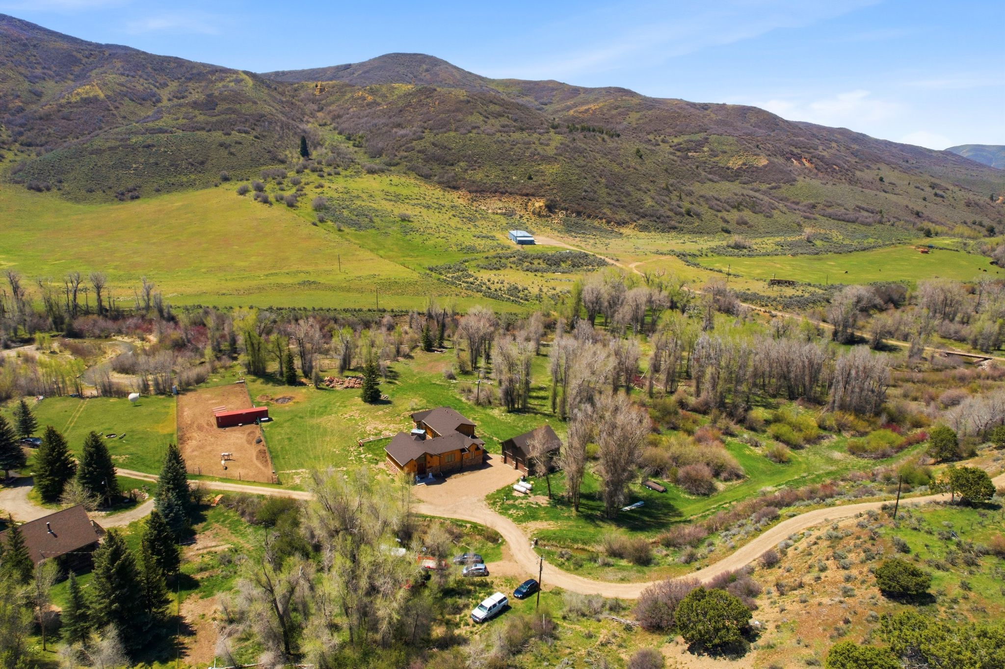 Expansive property featuring a multi-structure layout with a main residence and additional outbuildings