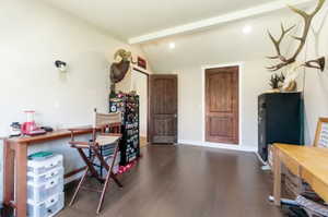 Spacious room featuring wood-finish flooring, light-toned walls, and recessed lighting