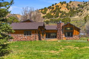 Contemporary exterior featuring wood siding and stone veneer