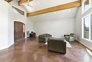 Vaulted ceiling great room featuring exposed wood beams, recessed lighting, and expansive windows
