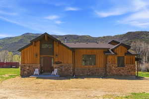 Wood-paneled exterior with natural stone accents and a dark-toned roof