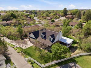 Spacious property featuring a large front yard with a white picket fence, a covered porch, and a two-car garage