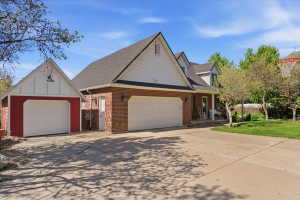 Brick and siding exterior with a multi-car driveway