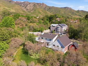 Expansive hillside property featuring multiple structures and natural surroundings