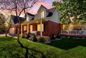 Brick and siding exterior with a covered porch and dormer windows