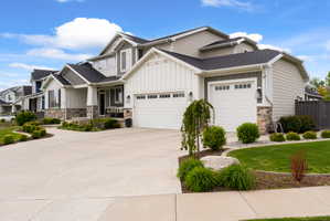 Contemporary two-story exterior featuring a stone and siding facade