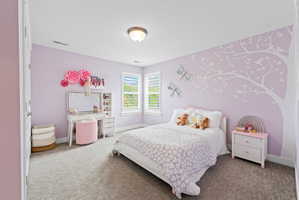 Room featuring wall-to-wall carpeting and multiple windows with plantation shutters