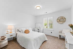 White walls and light-toned carpet create a bright interior