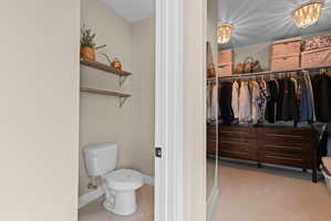 Walk-in closet featuring extensive built-in storage, integrated hanging rods, and recessed ceiling lighting