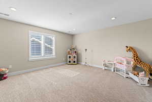 Room featuring light beige wall paint, white baseboards, and neutral-toned carpet flooring