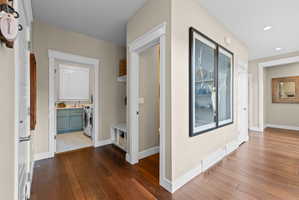 Hallway with wood-finish flooring, recessed lighting, and white baseboards