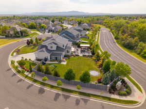 Contemporary residence featuring a light gray exterior, dark gray roof, and prominent dormer windows