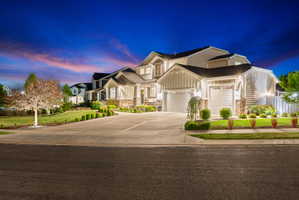 Multi-level property with an attached two-car garage and a paved driveway